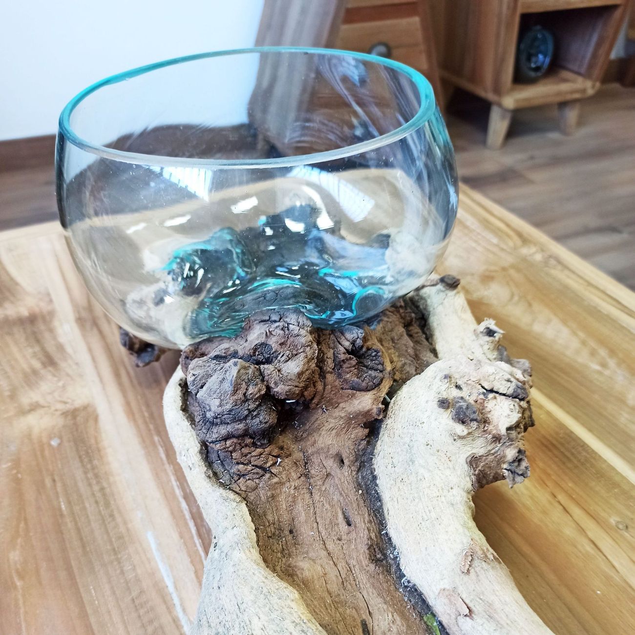 Photo non retouchée de la pièce posée sur une table en bois, coupe de verre soufflé vue de près